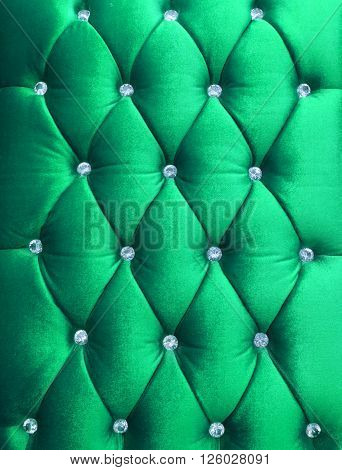 Green upholstery velveteen decorated with crystals as texture and pattern