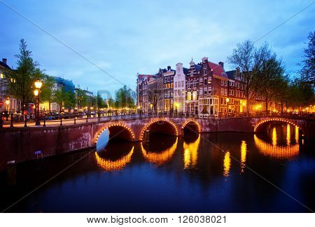 famous canals and bridgres  of Amsterdam in night, Netherlands, toned