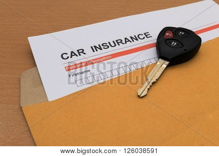 Car Insurance application form and key on brown envelope