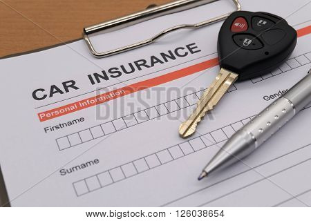 motor insurance with car key and pen