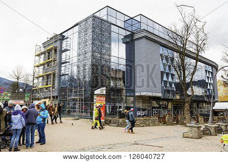 ZAKOPANE POLAND - MARCH 06 2016: The construction of a modern shopping mall work began in late 2011 then stopped and re-started in September 2014 now is close to completion of the works