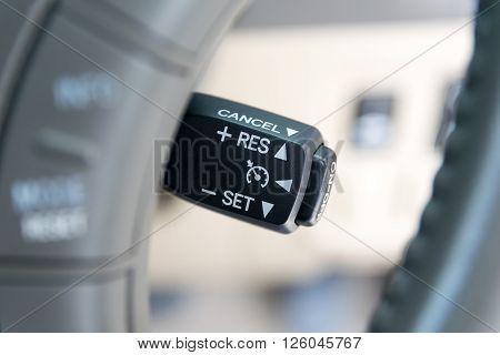 Cruise control buttons on modern car and speed limitation