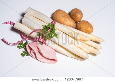 fresh white asparagus with checkered red white rope