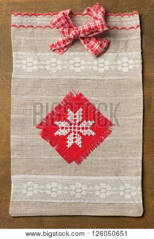 Knitted handmade Gift Bag on wood background