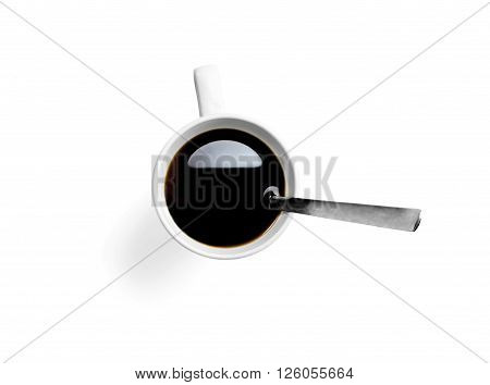 White cup of fresh tasty morning coffee with spoon shot from above.