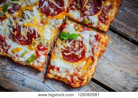 Square Pepperoni Pizza On Rustic Wooden Background
