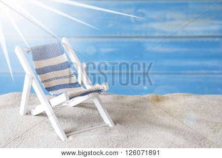 Summer Label With German Text Schoenen Urlaub Means Happy Holiday. Blue Wooden Background. Card With Holiday Greetings. Beach Vacation Symbolized By Sand, Deck Chair And Shell.