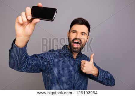 Happy Young Man Making Funny Selfie And Showing Thumb Up