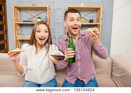 Surprised Happy Family Watching Film And Eating Pizza With Beer