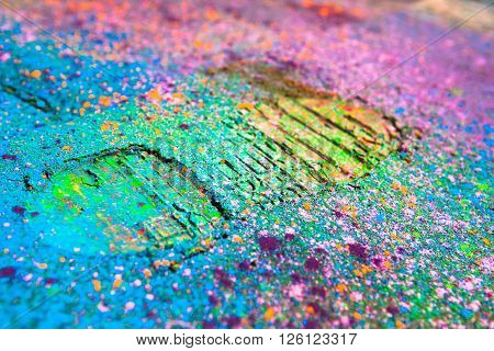 Shoe print on colorful powder background. Closeup