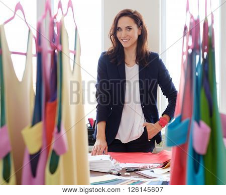 Beautiful young designer in her fashion atelier showroom.