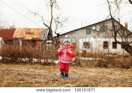 The Little children playing in the street.