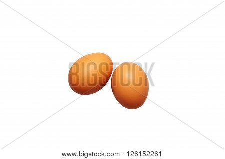 two fresh eggs on a white background. orange color. top view