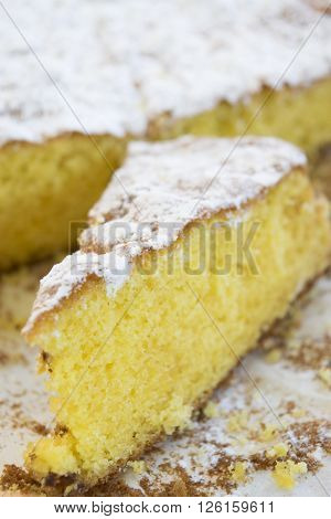 a slice of sponge cake with icing sugar