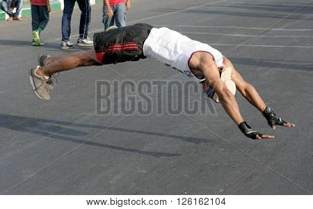 HYDERABAD,INDIA-MARCH 20: Indian man do push ups and jump up from the floor during raahgiri event on March 20,2016 in Hyderabad,India