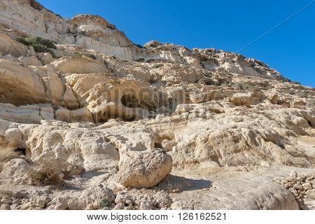 View on the caves in the sandstone cliffs of Matala. Crete Greece