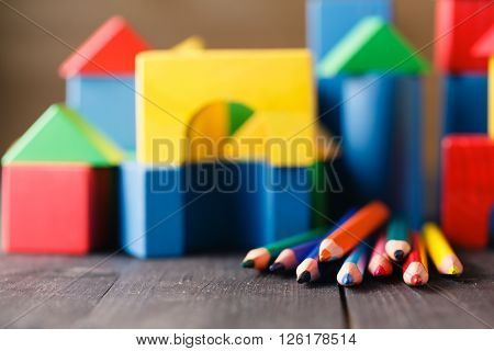 Different Colors Of Pencils Ontable With Building Blocks