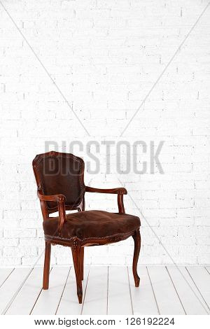 White interior with brown chair with wooden floor