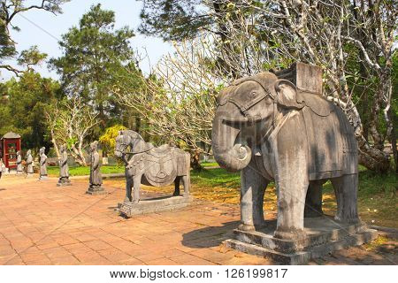 Stone statues of horse, elephant and people in Imperial Minh Mang Tomb of the Nguygen dynasty in Hue, Vietnam. UNESCO world heritage site