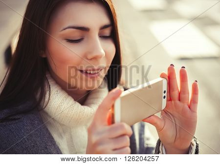 Young Girl Taking Photo On Her New Smart Phone