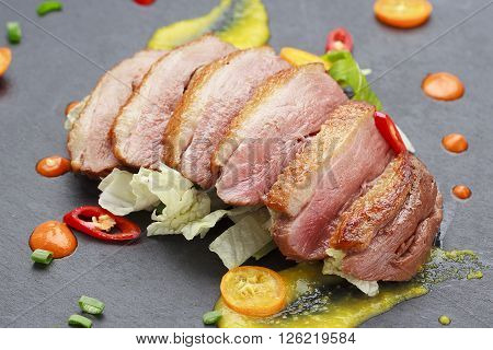 Pekin duck with vegetables over black background