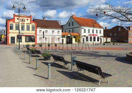 BAUSKA, LATVIA - APRIL 4, 2016: Central square of Bauska town with benches and color old houses.