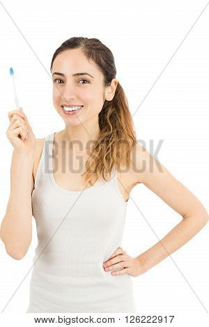 Smiling caucasian woman showing her toothbrush. Isolated on white backgrouhd.