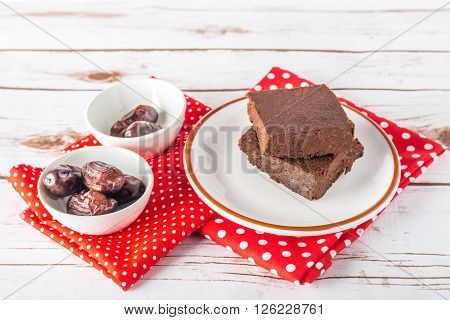 Healthy gluten free Paleo style brownies made with sweet potato dates and almond flour on a white plate