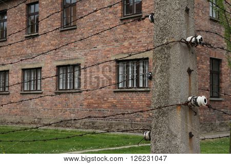Oswiecim, Poland - May 09, 2015: Electric Fence And Buildings In Former Nazi Concentration Camp Ausc