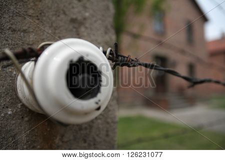 Oswiecim, Poland - May 09, 2015: Closeup View Of Electric Fence In Former Nazi Concentration Camp Au
