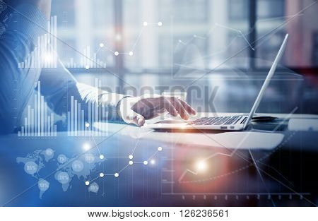 Business concept photo.Businessman working investment project modern office.Touching pad contemporary laptop. Worldwide connection technology, stock exchanges graphics interface.