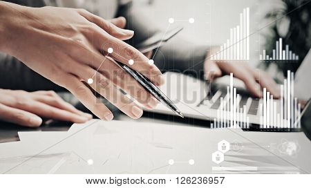 Picture of female hands with pen.Businessmans crew working investment project modern office.Using contemporary laptop. Worldwide connection technology icons, stock exchanges graphics interface.