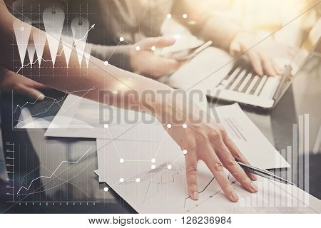 Picture of female hands with pen.Businessmans team working investment project modern office.Using contemporary laptop. Worldwide connection technology icons, stock exchanges graphics interface.