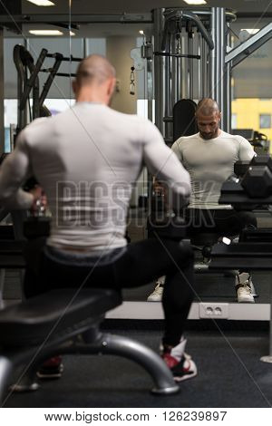 Young Man Resting In Healthy Club After Exercising