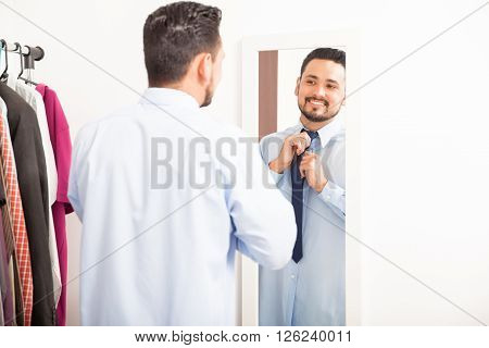 Man Putting On Necktie In A Dressing Room