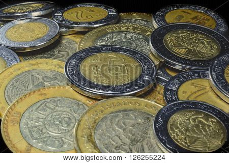 pesos coins in different denominations in a pile from 1 to 15 pesos.