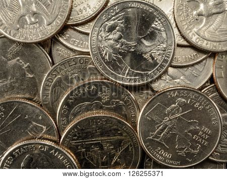 United States Coins quarters in a pile poverty riches savings thrift old and new state coins George Washington