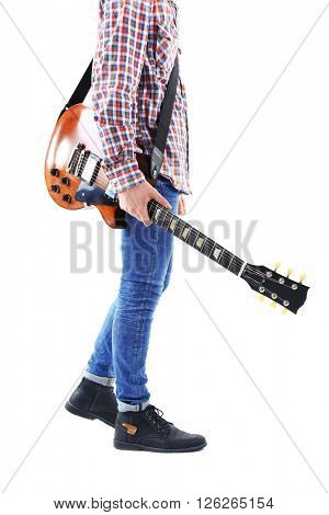 Young man in blue jeans going right with electric guitar, isolated on white