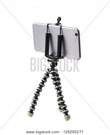 Smartphone set up on a tripod isolated over the white background