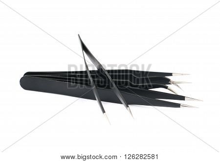 Pile of black metal anti-static tweezers tools isolated over the white background