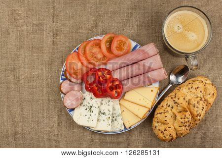 Breakfast on the table. Ham, tomato and cheese for breakfast with bread. Homemade healthy food. Vegetables and ham for breakfast.