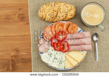 Breakfast on the table. Ham, tomato and cheese for breakfast with bread. Homemade healthy food. Vegetables and ham for breakfast.