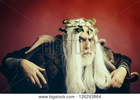 Zeus god man or jupiter with antlers and vine crown on long hair with beard