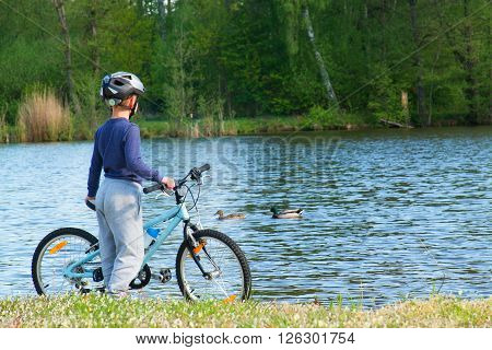 Small Boy, Bikerider In Sport Helmet  On The Beach.