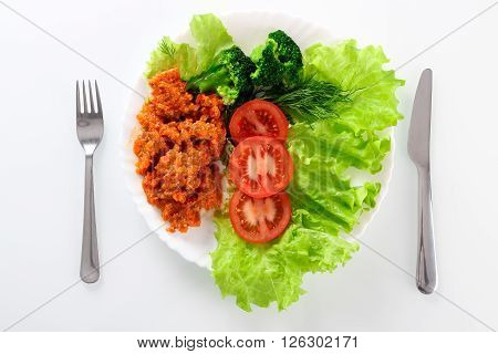 Fresh salad with lettuce broccolli tomato and meat on dish