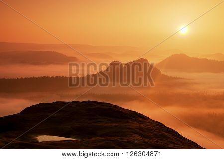 Dreamy Misty Landscape. Majestic Mountain Cut The Lighting Mist. Deep Valley Is Full Of Colorful Fog