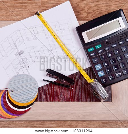 construction and architectural design concept. 3D visualization of the kitchen project under construction with wooden and plastic panels, a calculator and a color palette on the blurry figures.