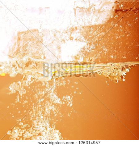 Splashes of fresh beer on tap closeup. Background