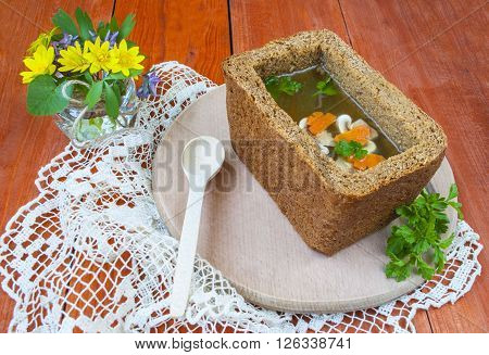 soup in a bowl of bread, soup with mushrooms and carrots.
