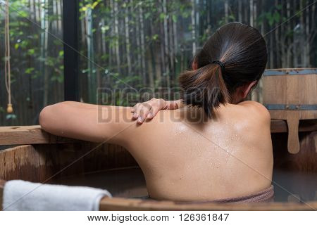 Onsen series : Unrecognizable woman in wooden bathtub